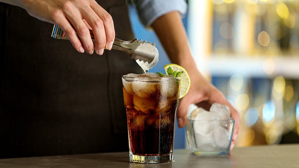 bartender preparing vodka soda beverage