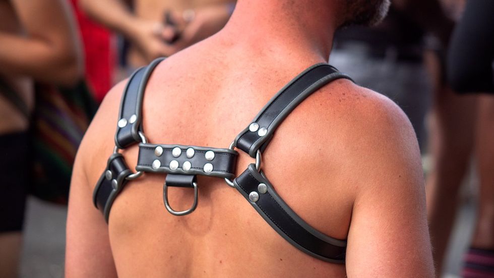 black leather chest harness from the back