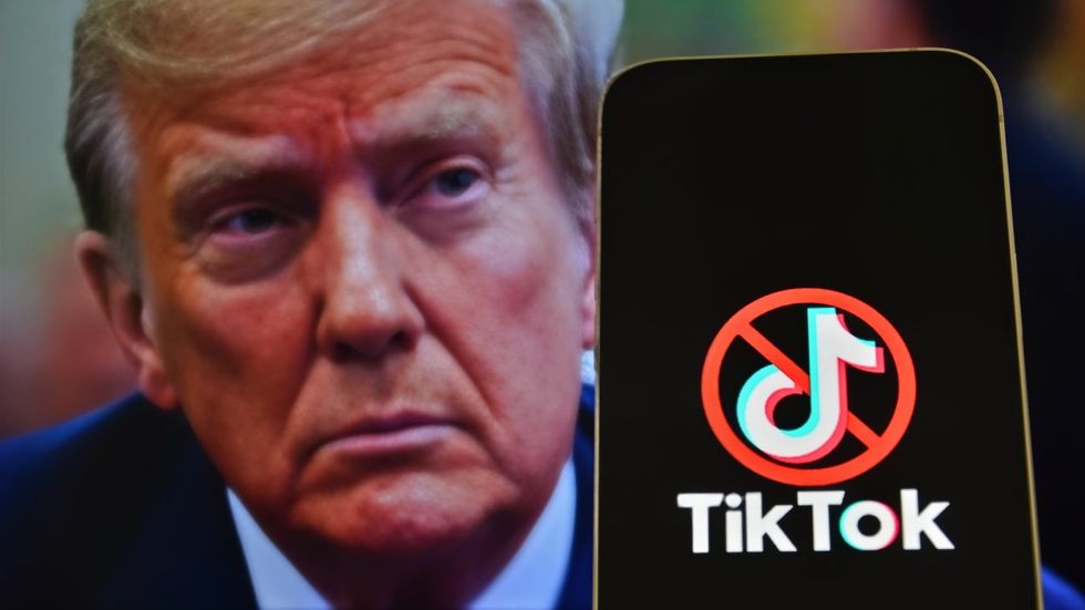 Donald Trump behind a phone with the TikTok logo