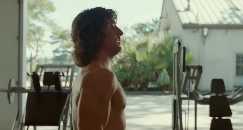 Zac Efron Is All Sweat, Muscles, & Wrestling Trunks in 'The Iron