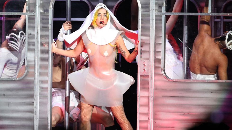 Lady Gaga concert performance nun subway car shirtless men dancing