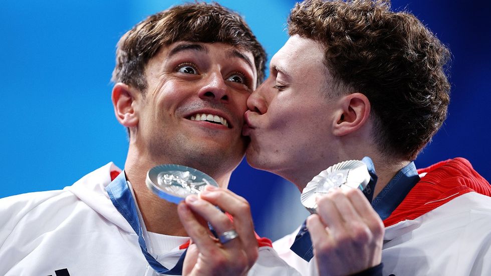 Silver Medalists Thomas Daley and Noah Williams of Team Great Britain celebrate kiss as they pose following Diving medal ceremony Mens Synchronised 10m Platform Final day three Olympic Games Paris France 2024