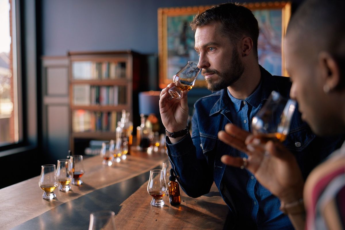 Two men are sipping bourbon at a tasting.